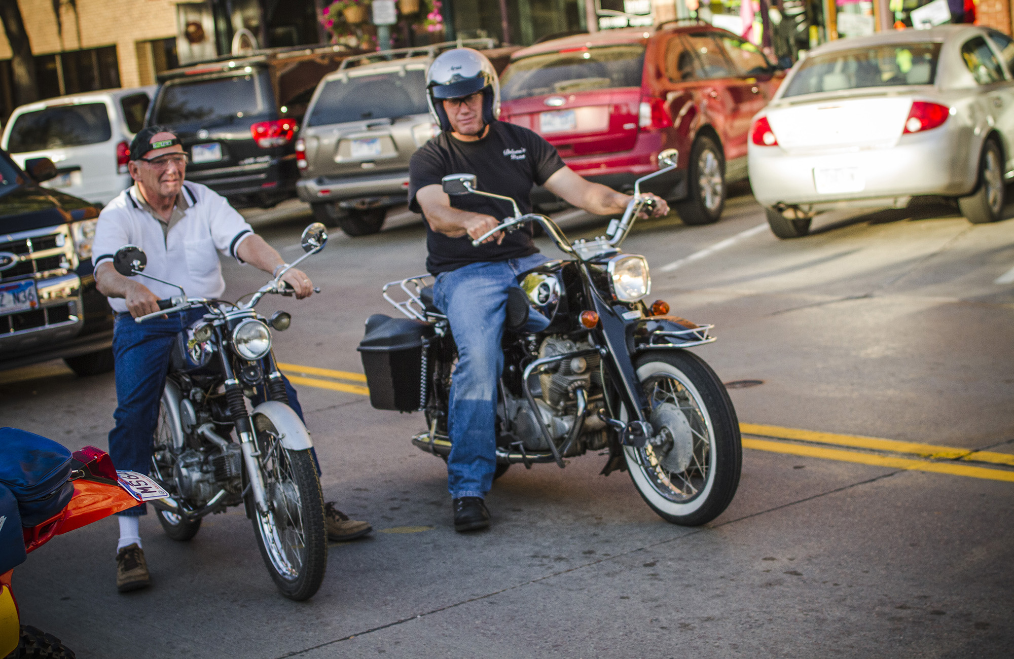 Two people side by side on Motorcycles